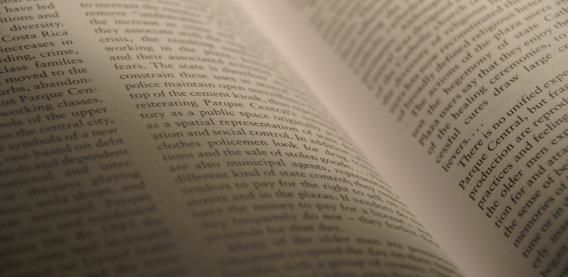 Image of an open book with printed text. Illustrative.